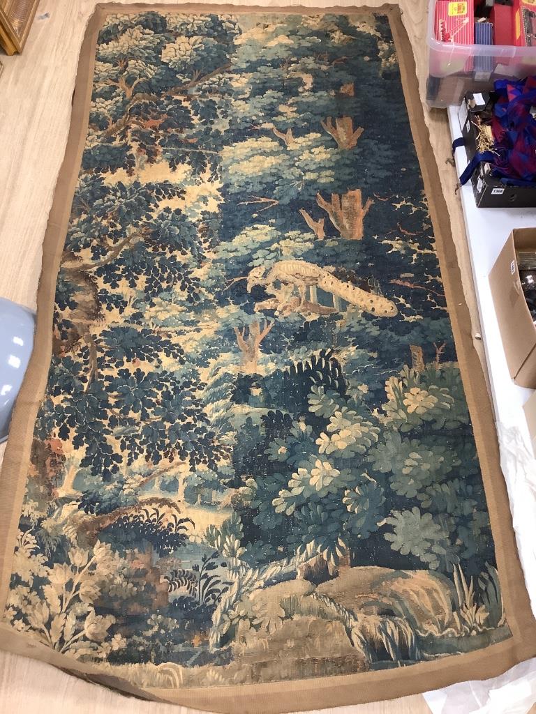 An early 17th century Aubusson tapestry, worked with a peacock in a landscape (worn in places and reduced)